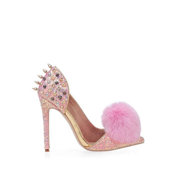 Pink-colored front fur pom women's pointed heels with metallic spike stud accents and slip on design-side view