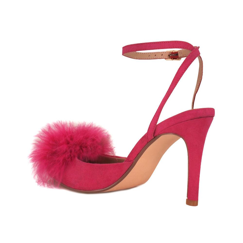 Women's fuchsia-colored pointed-toe heels with front fur pom top and ankle buckle closure-posterior view