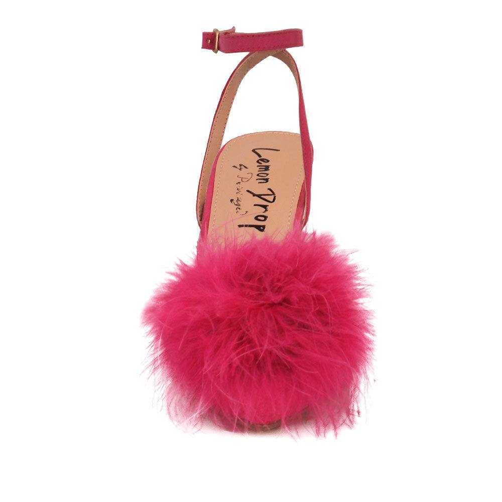 Women's fuchsia-colored pointed-toe heels with front fur pom top and ankle buckle closure-front view