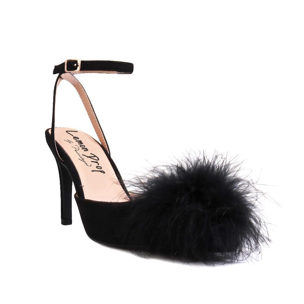 Black-colored women's pointed-toe heels with front fur pom upper and ankle buckle closure-corner view