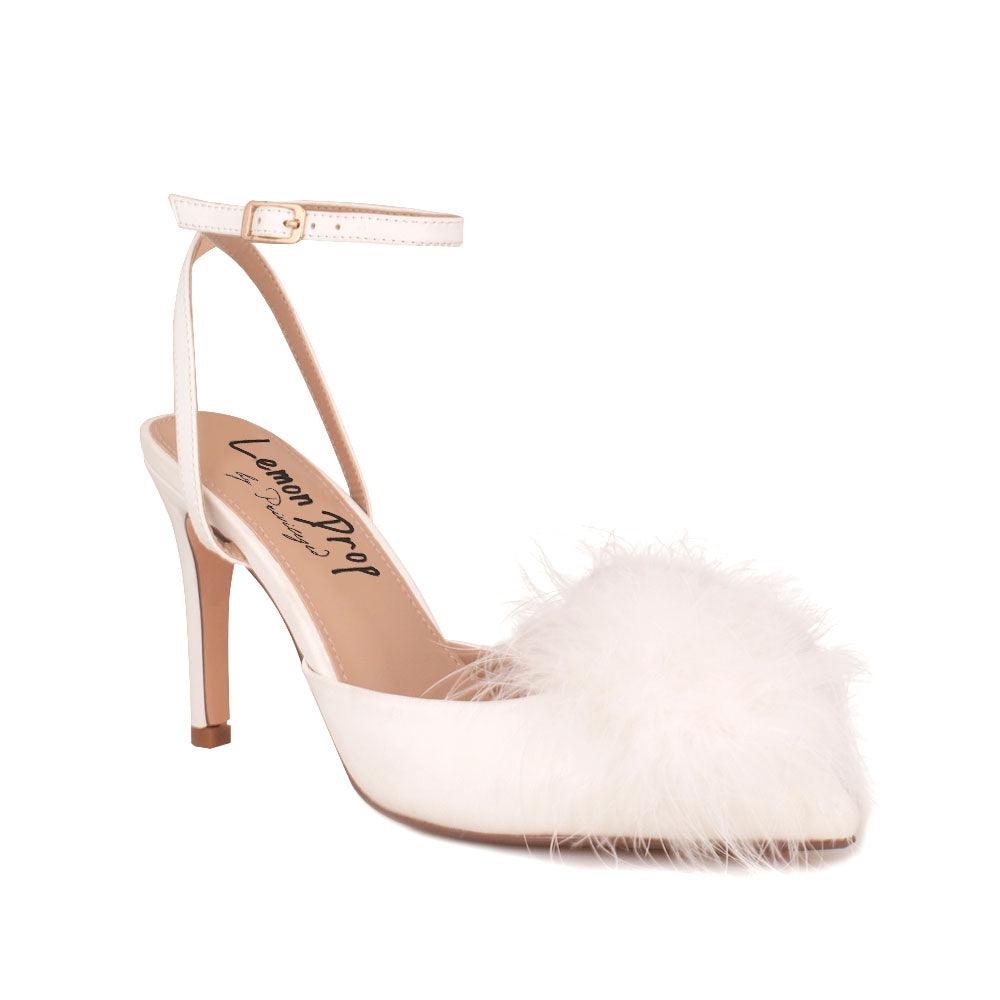 Women's white-colored pointed-toe heels with front fur pom top and ankle buckle fastening-corner view