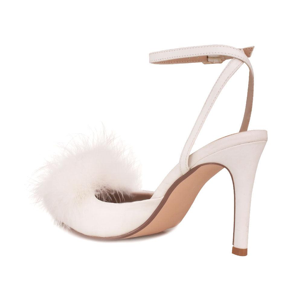 Women's white-colored pointed-toe heels with front fur pom top and ankle buckle fastening-posterior view