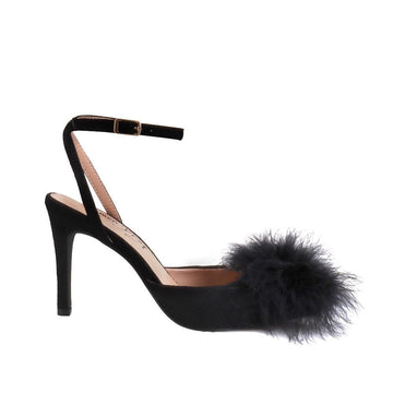 Black-colored women's pointed-toe heels with front fur pom upper and ankle buckle closure-side view