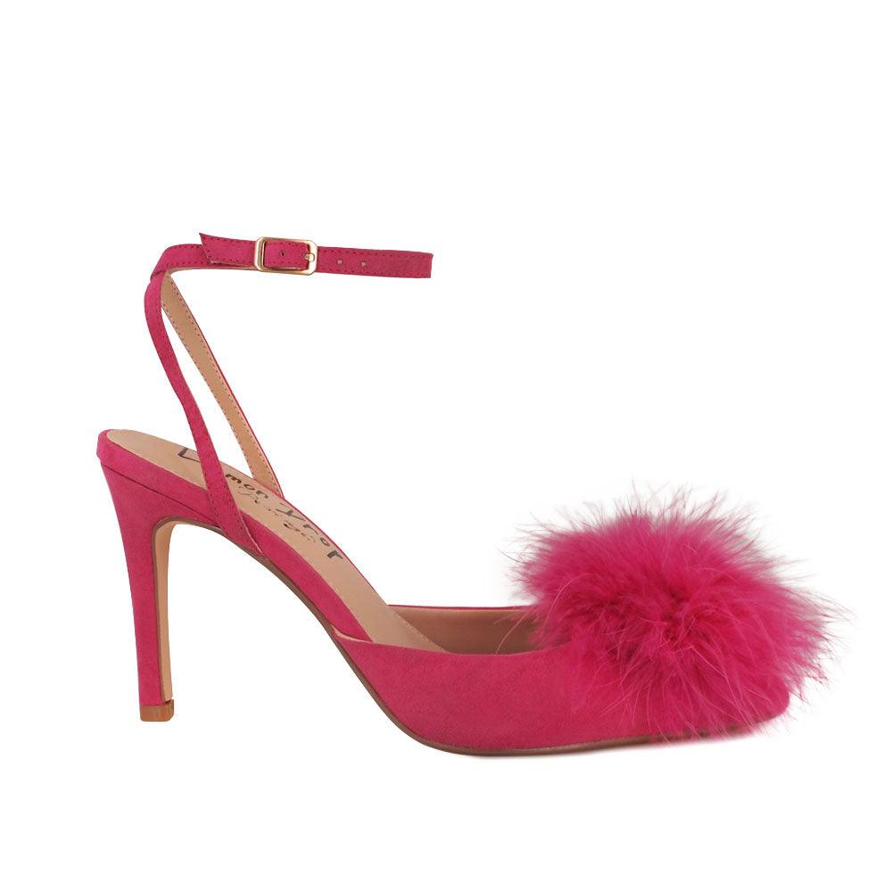 Women's fuchsia-colored pointed-toe heels with front fur pom top and ankle buckle closure-side view