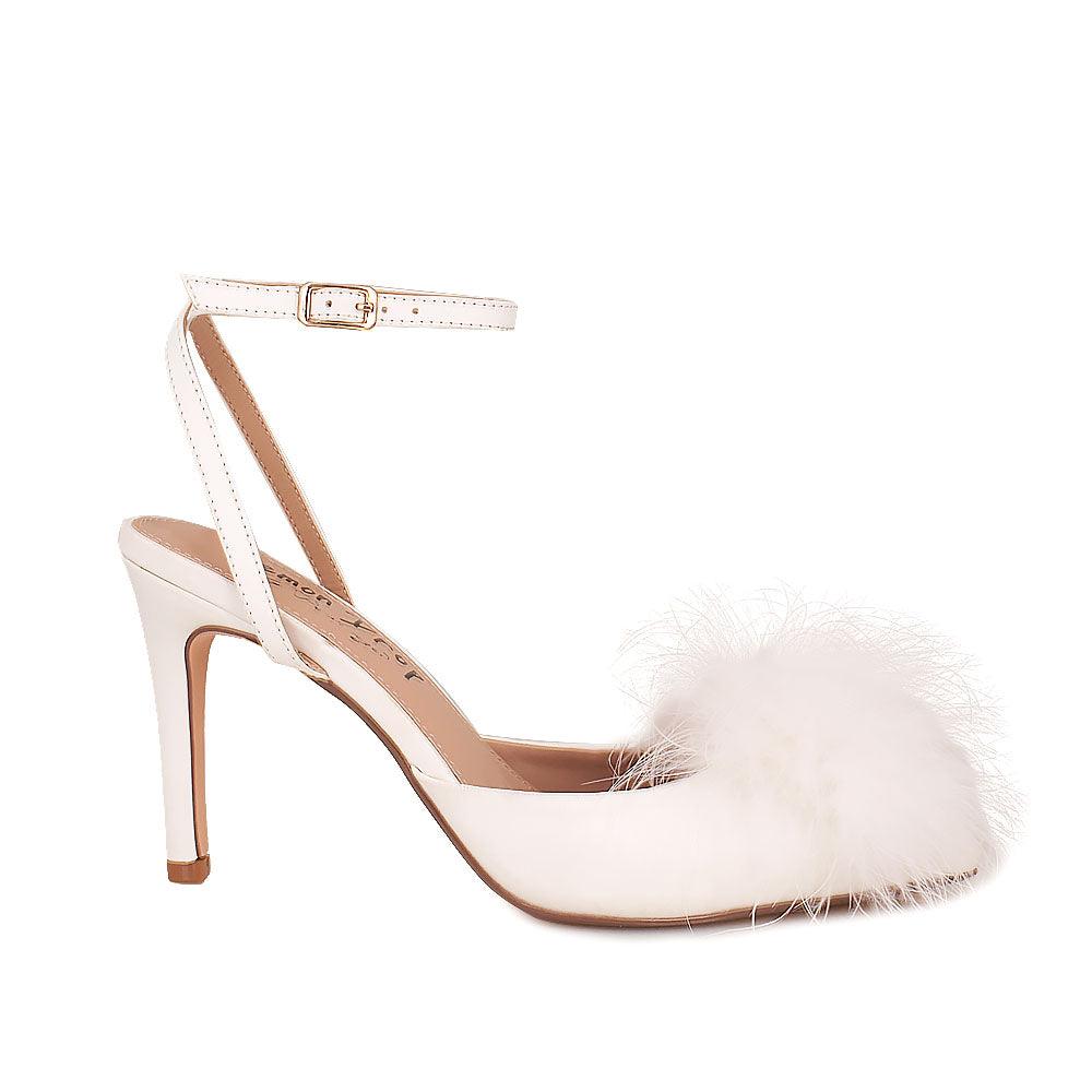 Women's white-colored pointed-toe heels with front fur pom top and ankle buckle fastening-side view