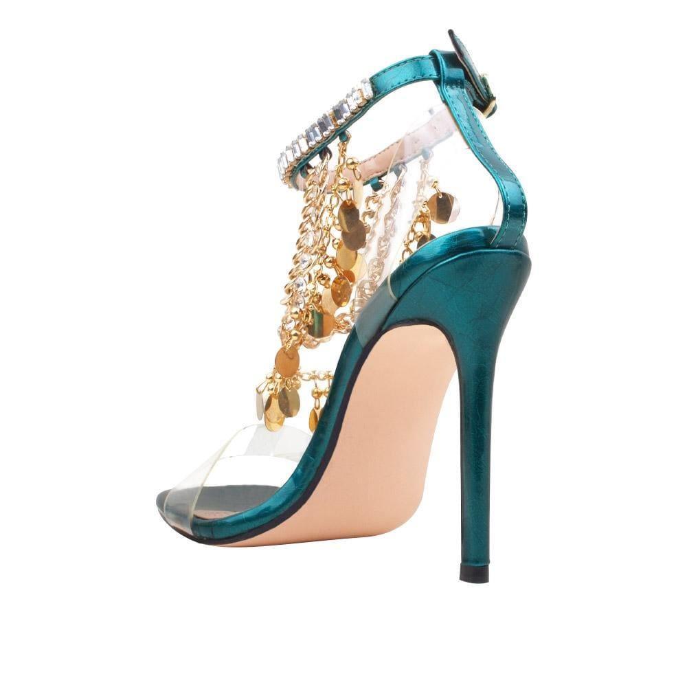 Women's green-colored heel with gold chains, rhinestones, metallic gold charms, and ankle buckle closure-posterior view