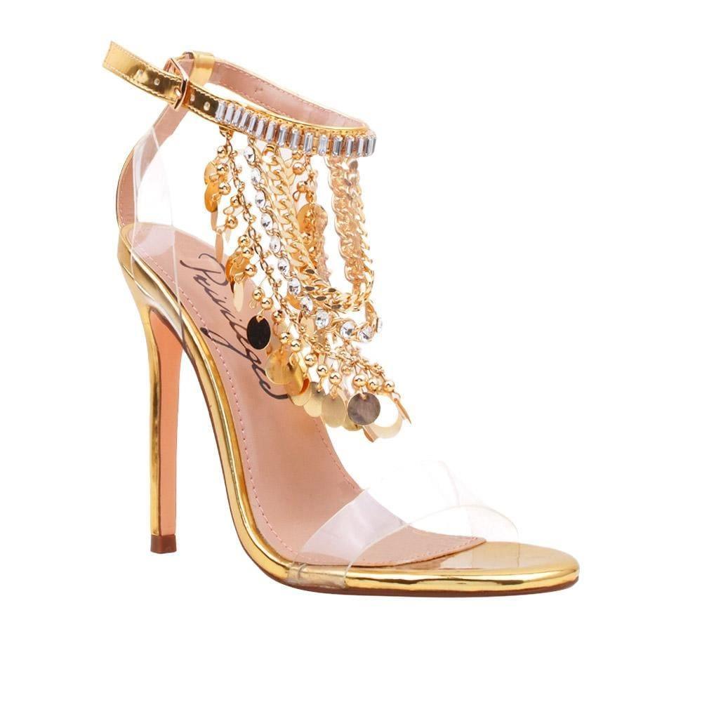 Golden-colored heel with clear strap gold chains, rhinestones, metallic gold charms upper, and ankle buckle fastening for women-corner view