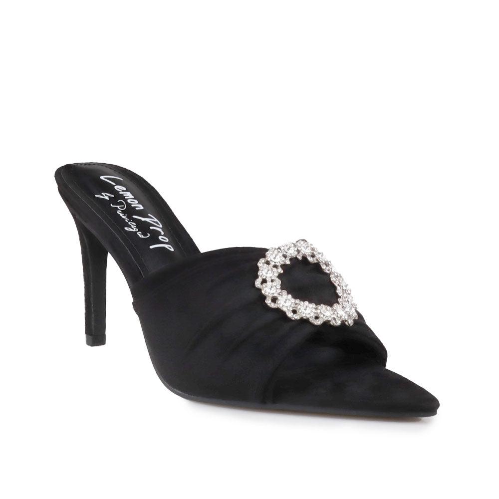 Black-colored brooch-encrusted slip-on shoes with an open toe for women-corner view