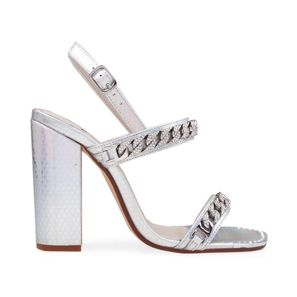 White-colored women's block heels with rhinestone-encrusted metal chain and buckle clasp