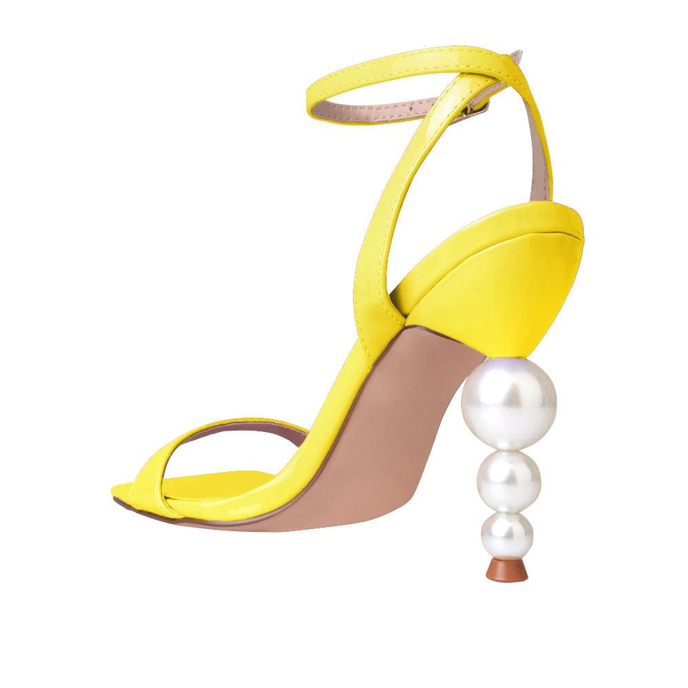 Yellow colored women heels with ankle buckle closure and three tiered pearl heel-posterior view