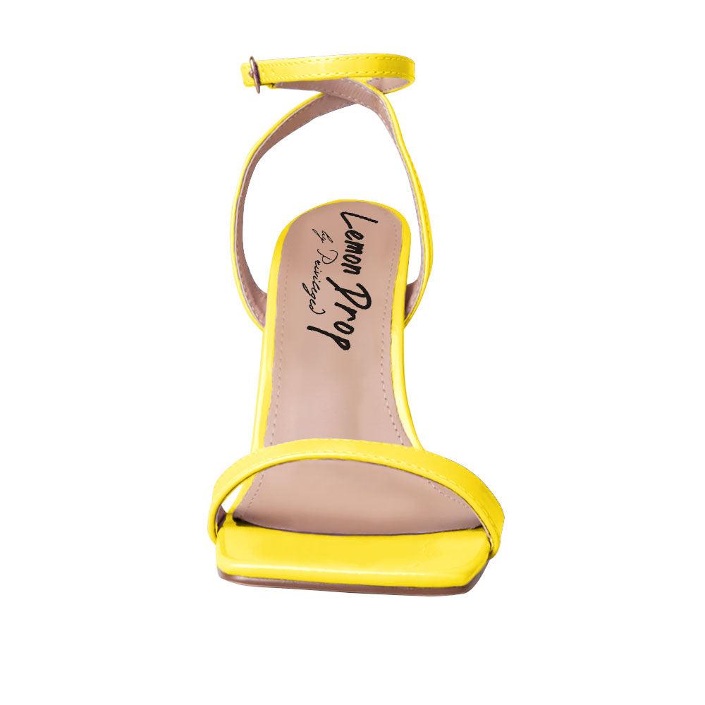 Yellow colored women heels with ankle buckle closure and three tiered pearl heel-front view