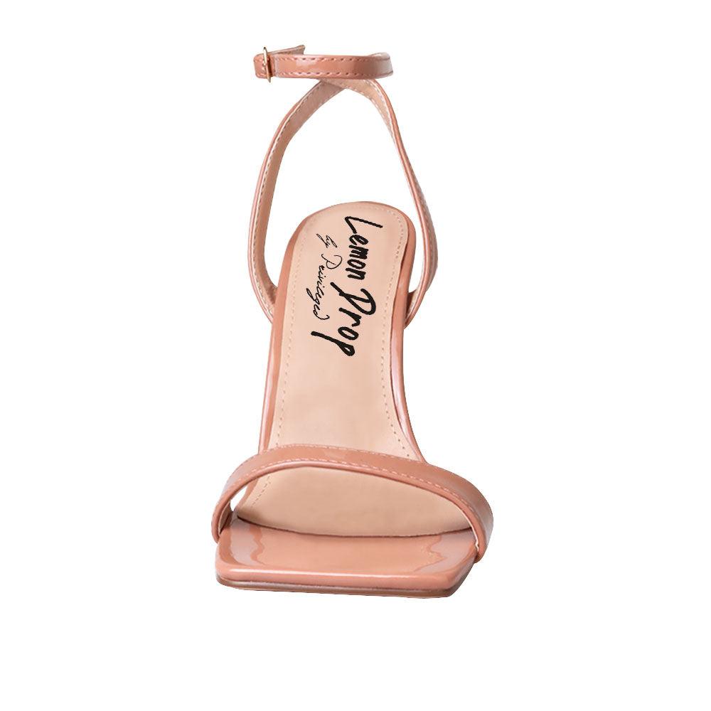 Nude colored women heels with ankle buckle closure and three tiered pearl heel-front view