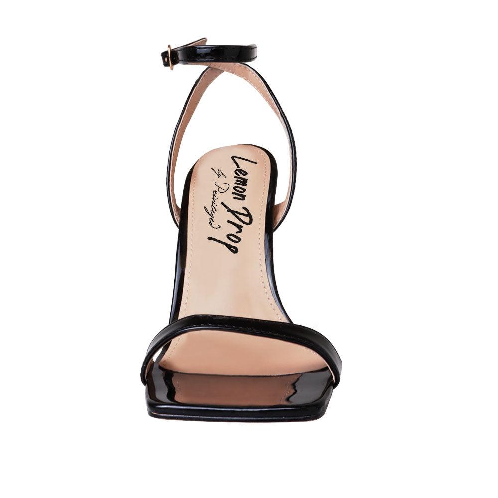 Black colored women heels with ankle buckle closure and three tiered pearl heel-front view