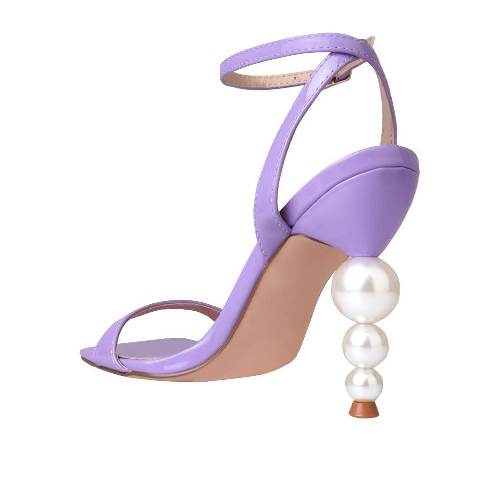 Purple colored women heels with ankle buckle closure and three tiered pearl heel-posterior view