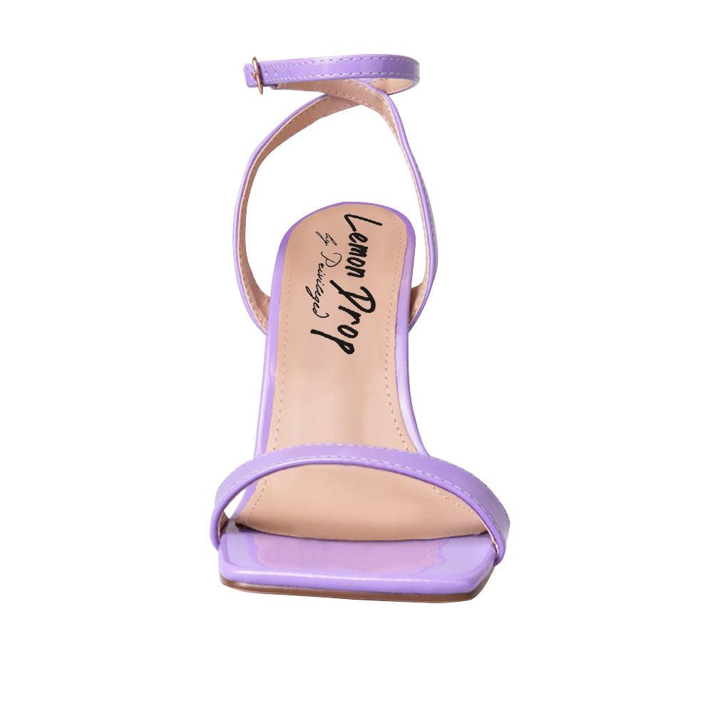 Purple colored women heels with ankle buckle closure and three tiered pearl heel-front view