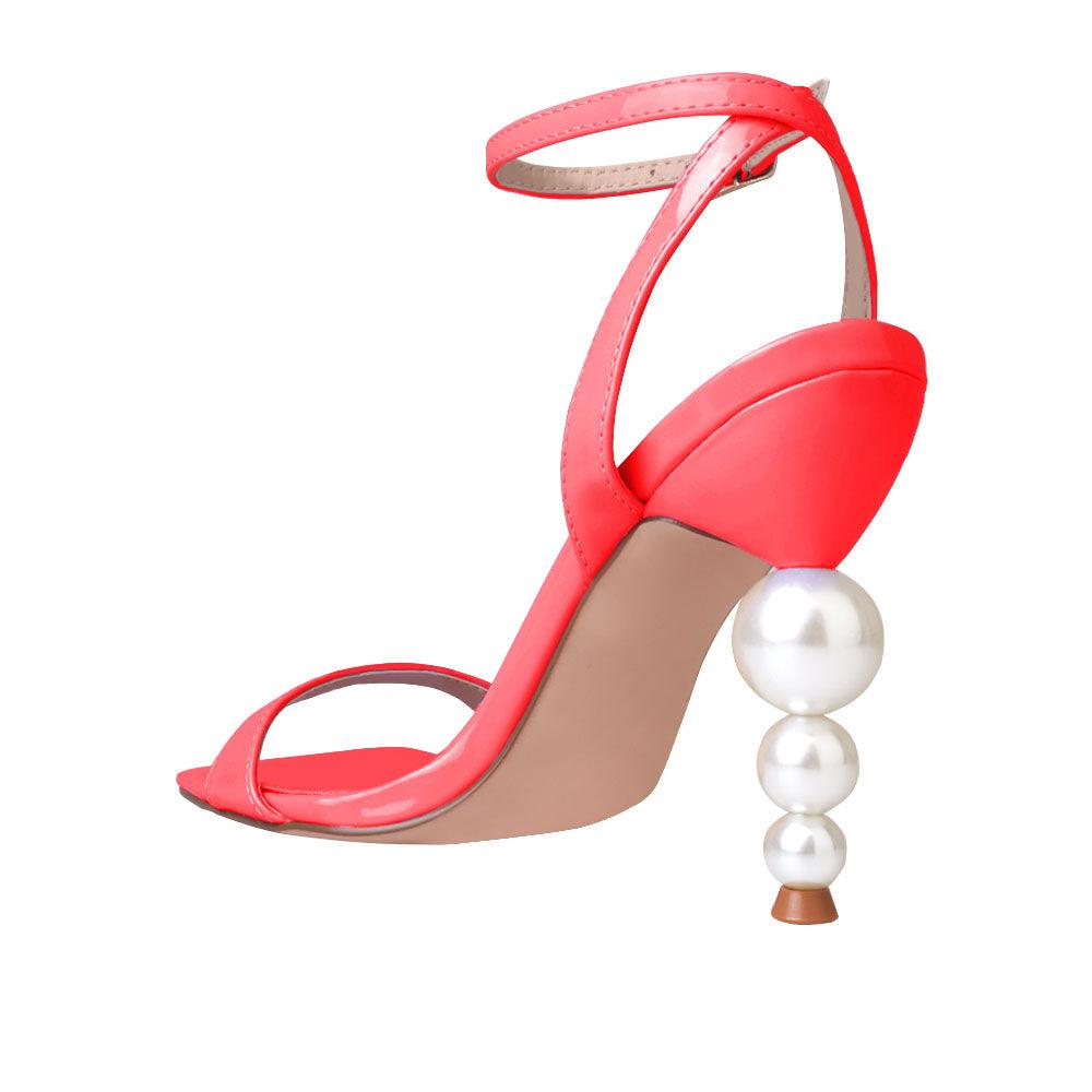 Red colored women heels with ankle buckle closure and three tiered pearl heel-posterior view