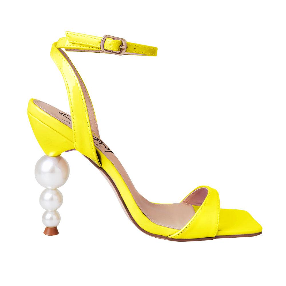 Yellow colored women heels with ankle buckle closure and three tiered pearl heel-side view