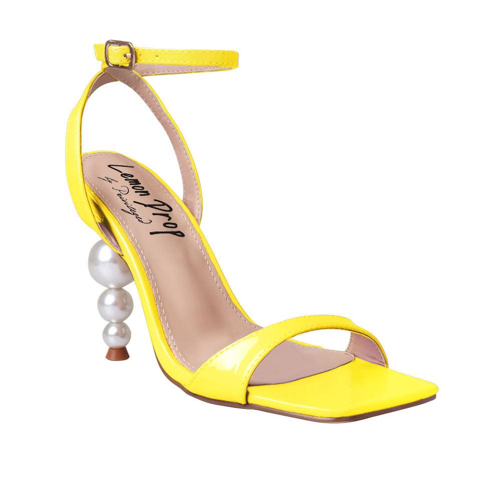 Yellow colored women heels with ankle buckle closure and three tiered pearl heel-corner view