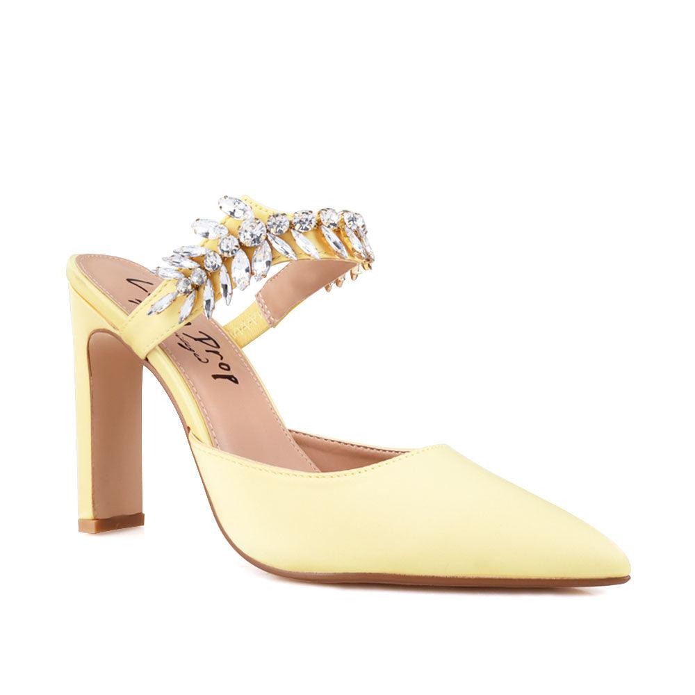 Yellow colored women heels with slip-on desgin and a silver motive strap-corner view