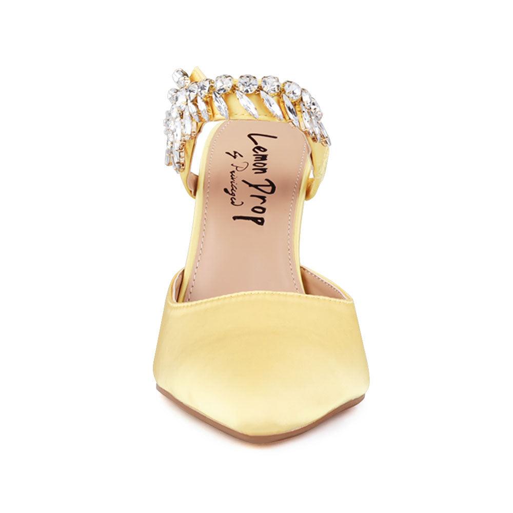 Yellow colored women heels with slip-on desgin and a silver motive strap-front view