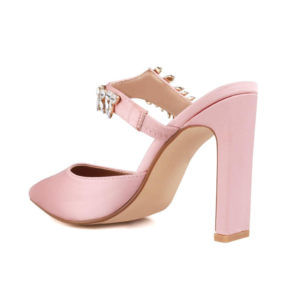 Rose gold colored women heels with slip-on desgin and a silver motive strap-posterior view