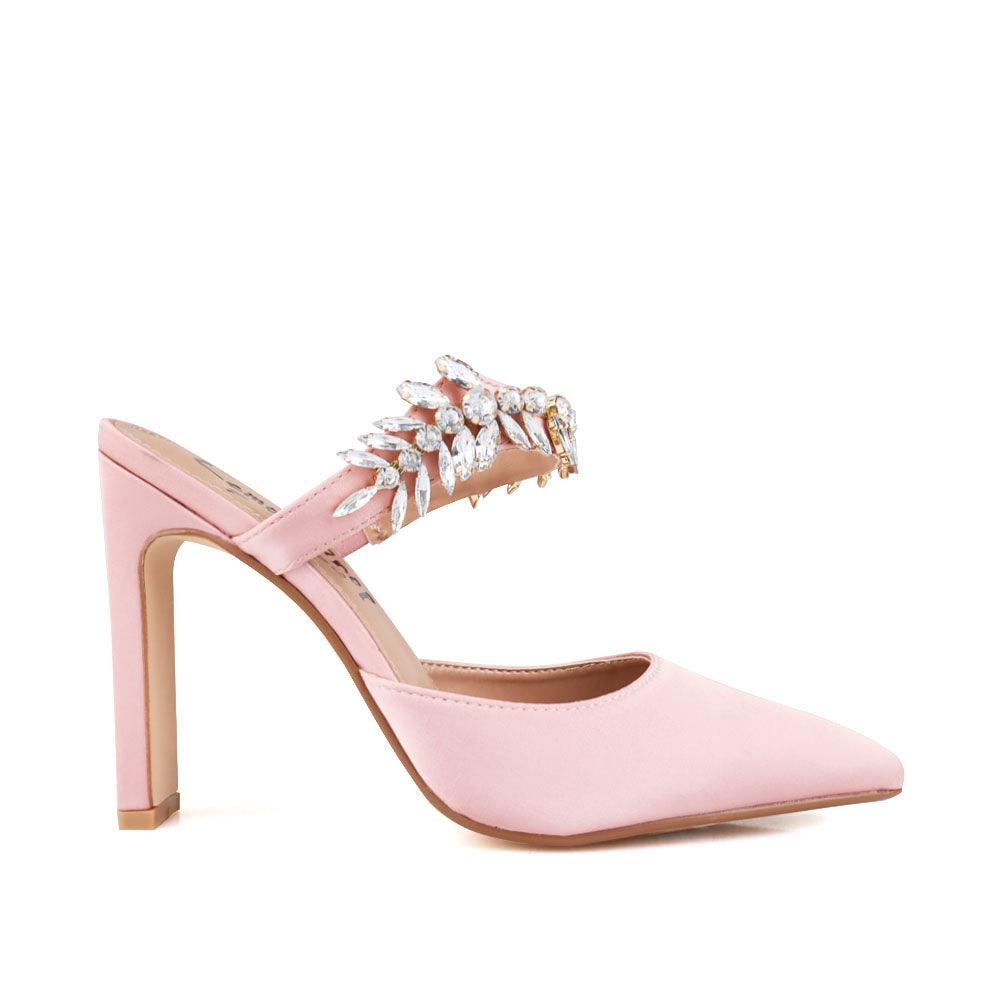 Rose gold colored women heels with slip-on desgin and a silver motive strap-side view