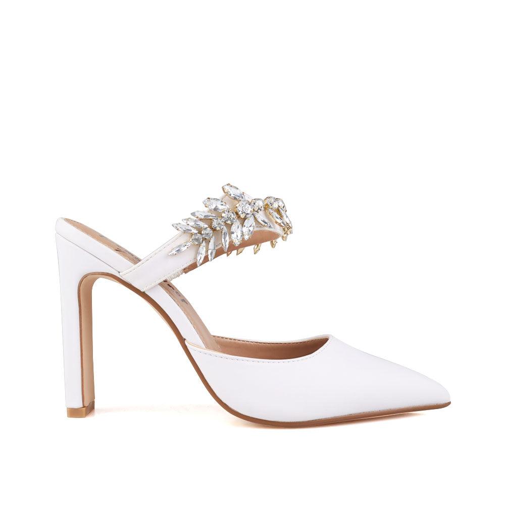 White colored women heels with slip-on desgin and a silver motive strap-side view