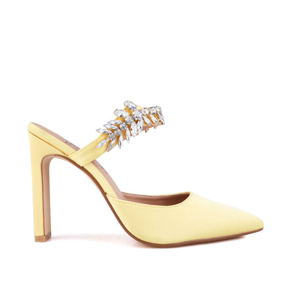 Yellow colored women heels with slip-on desgin and a silver motive strap-side view