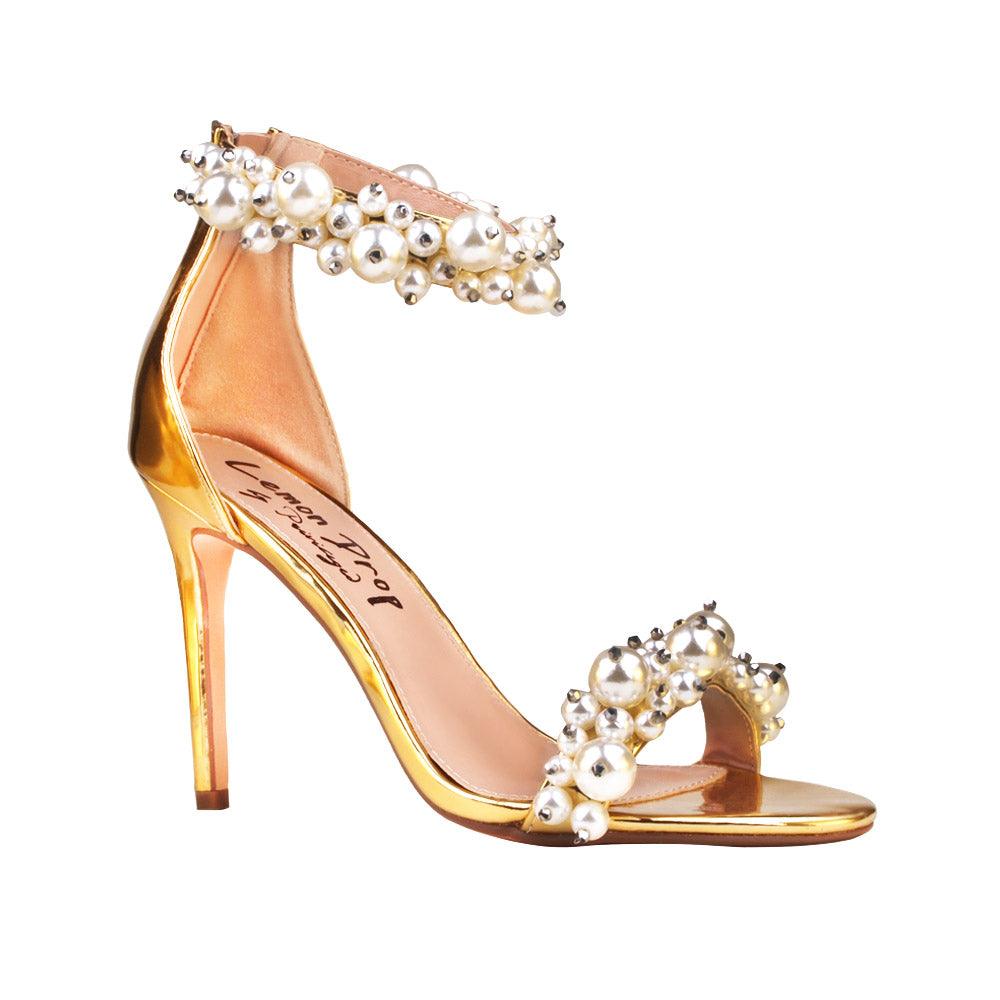 Golden women heels with pearl embellished ankle buckle and upper-corner view