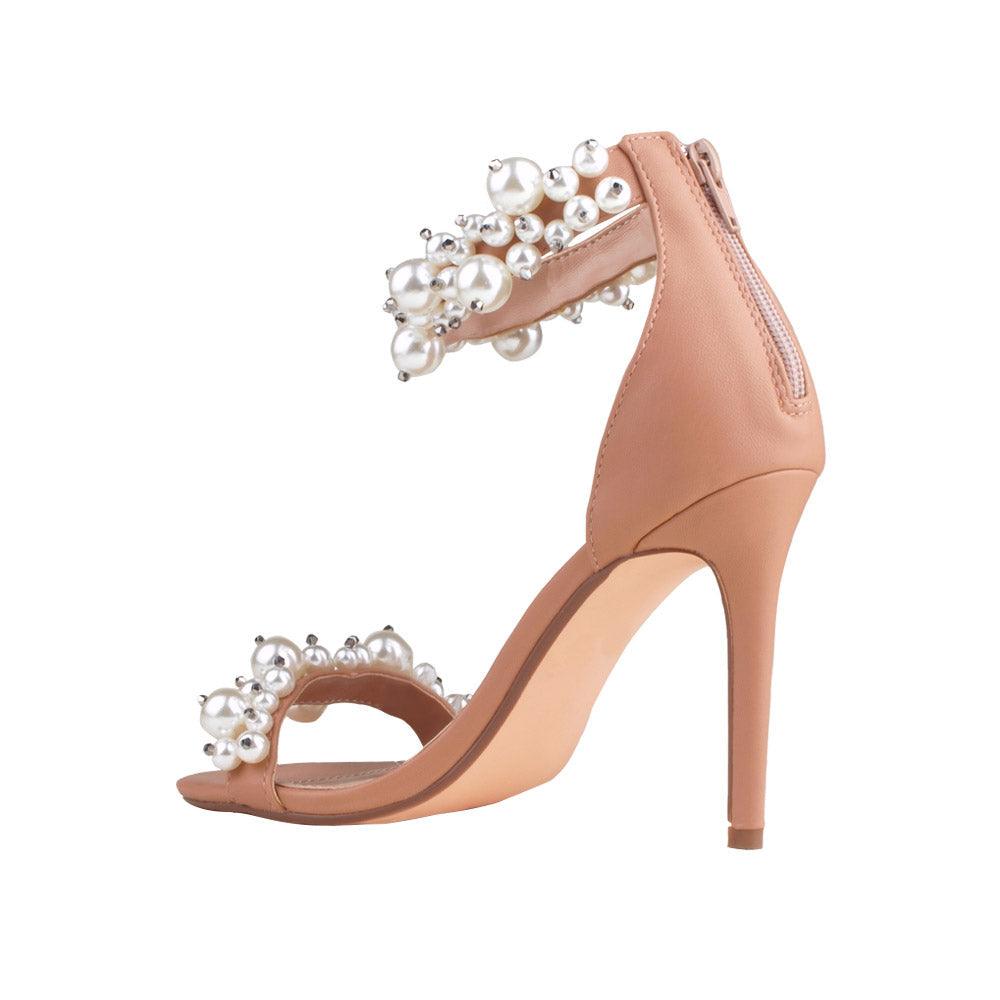 Tan colored women heels with pearl embellished ankle buckle and upper-posterior view