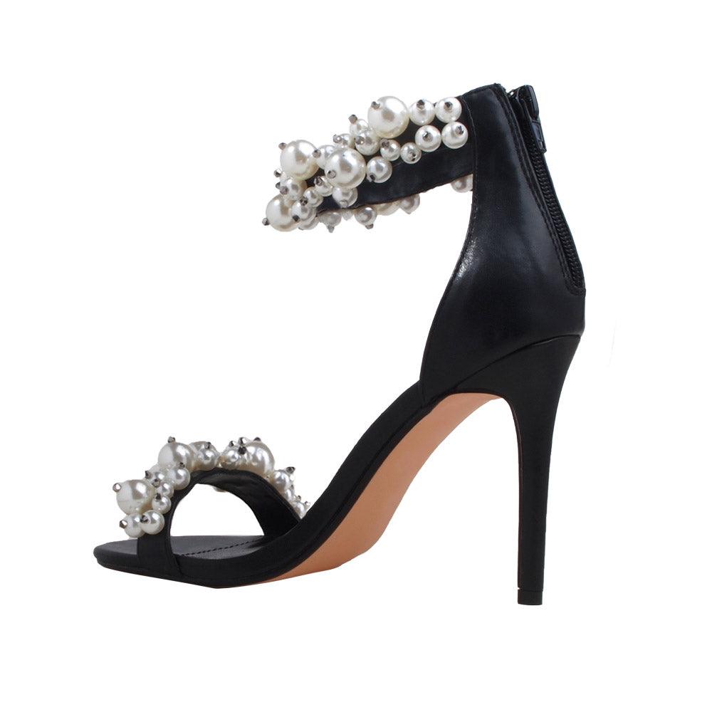 Black women heels with pearl embellished ankle buckle and upper-posterior view