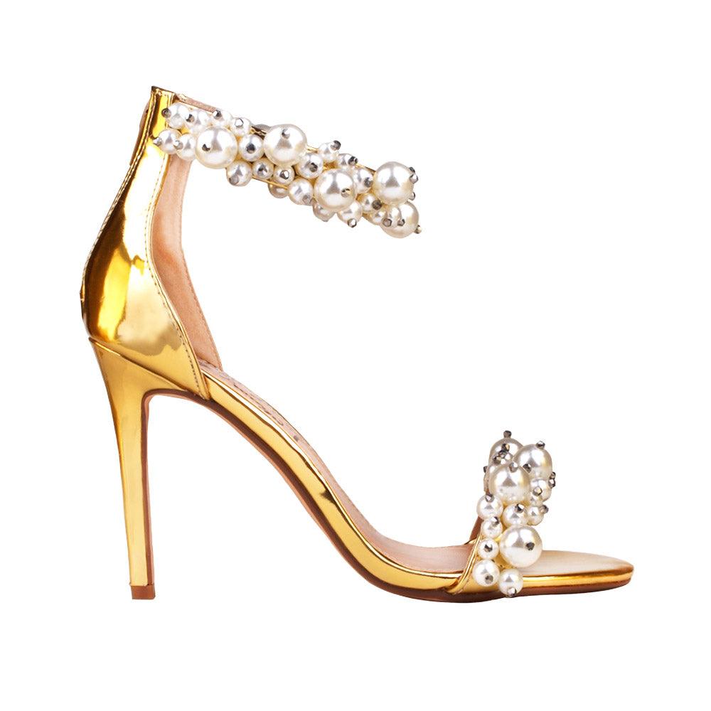 Golden women heels with pearl embellished ankle buckle and upper-side view