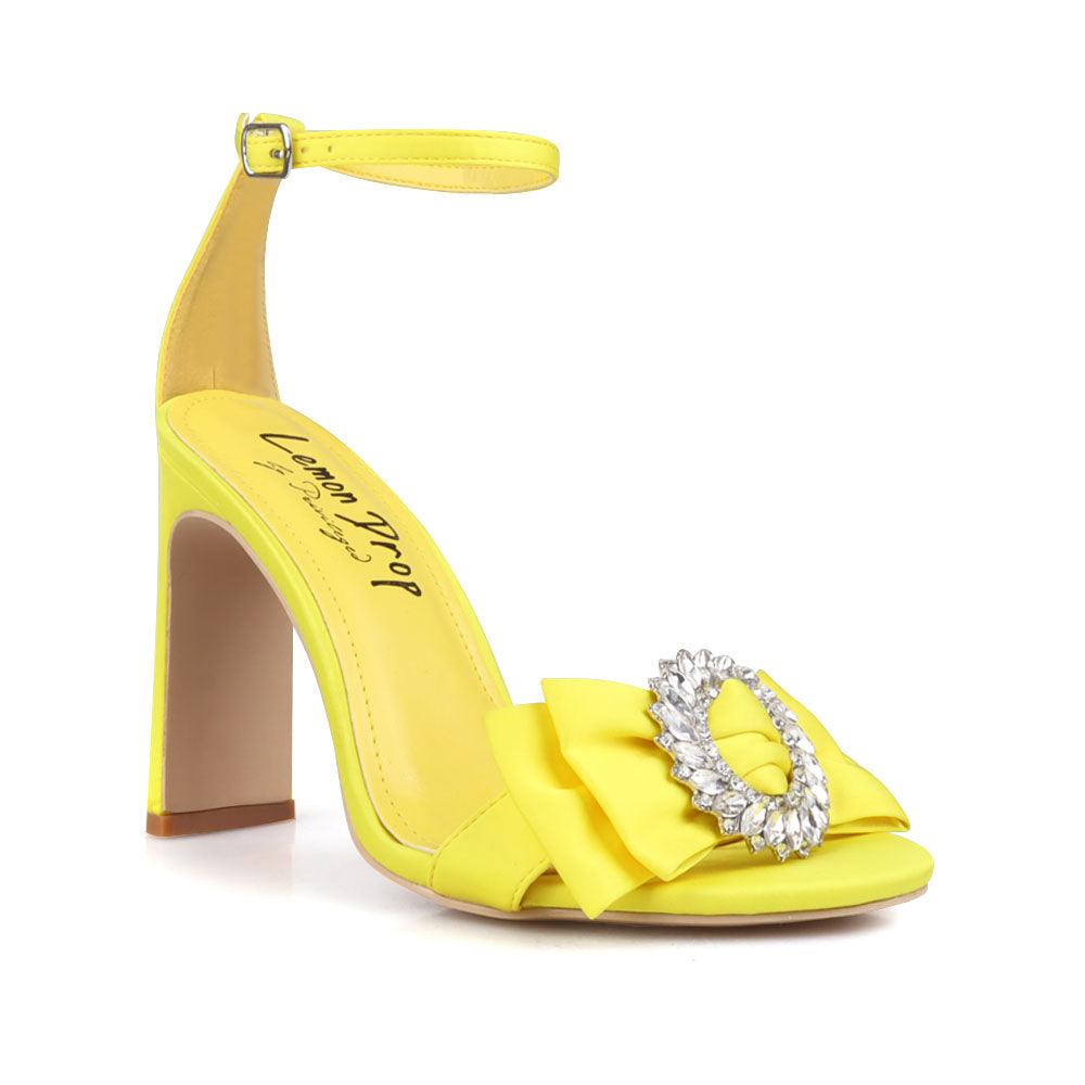 Mustard colored women heels with silver bow on upper-corner view