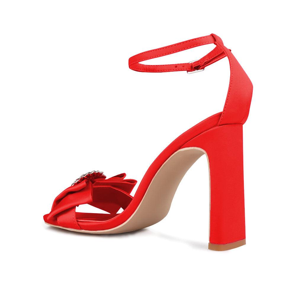 Red colored women heels with silver bow on upper-posterior view