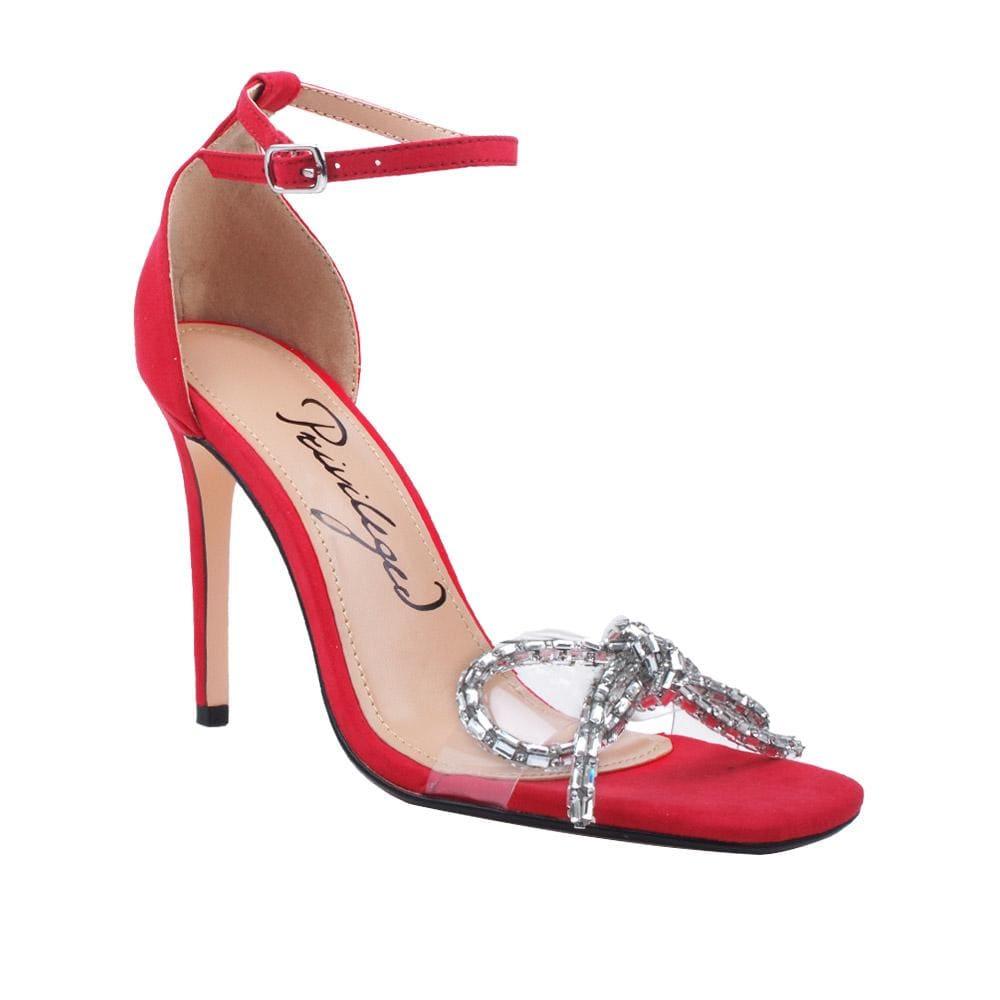 Red women heels with ankle closure and clear vinyl upper -corner view