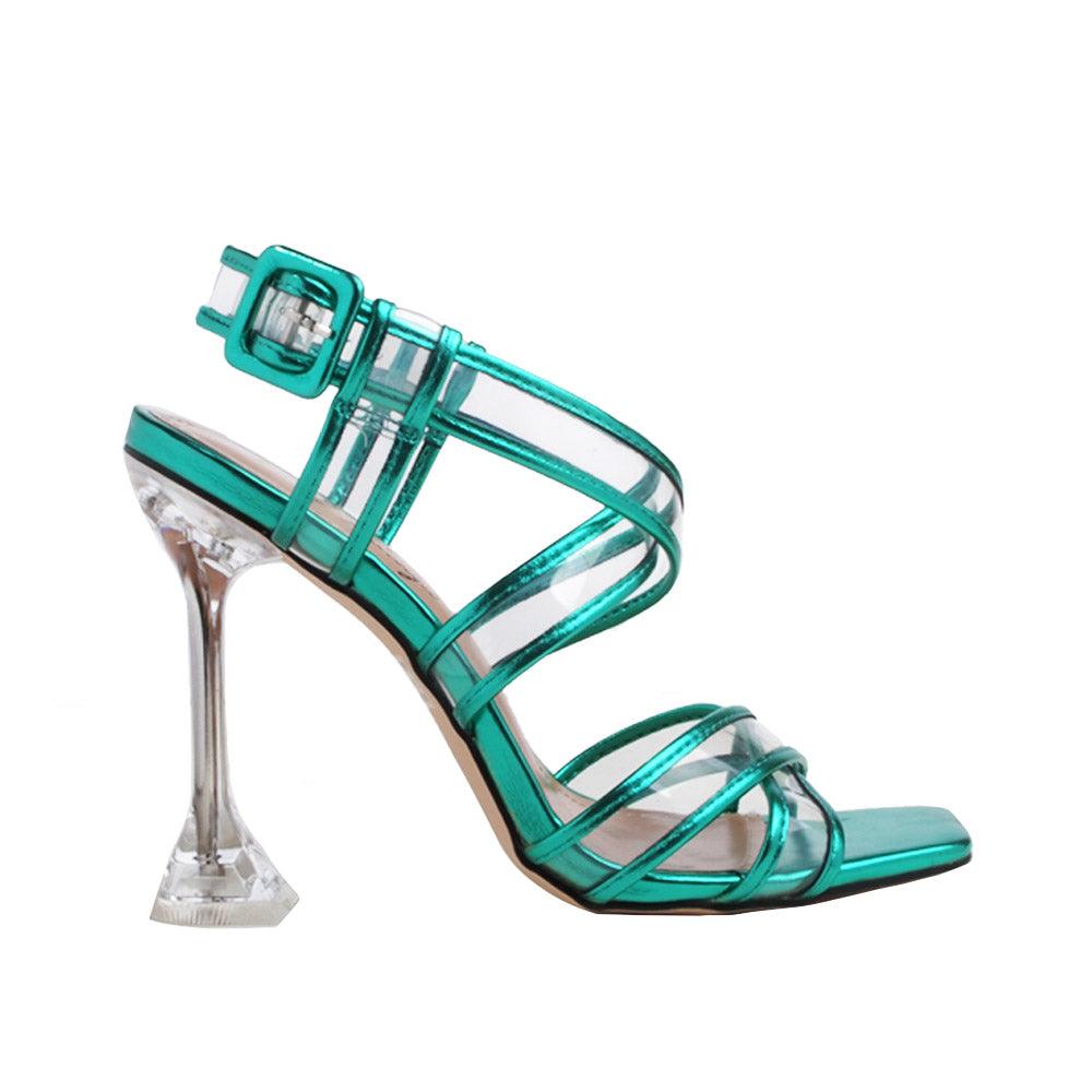 Green heels with a clear vinyl strap design and ankle buckle fastening.