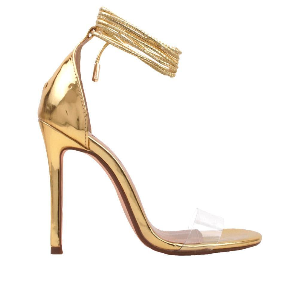 Golden women's heels with a clear strap and ankle tie clasp.