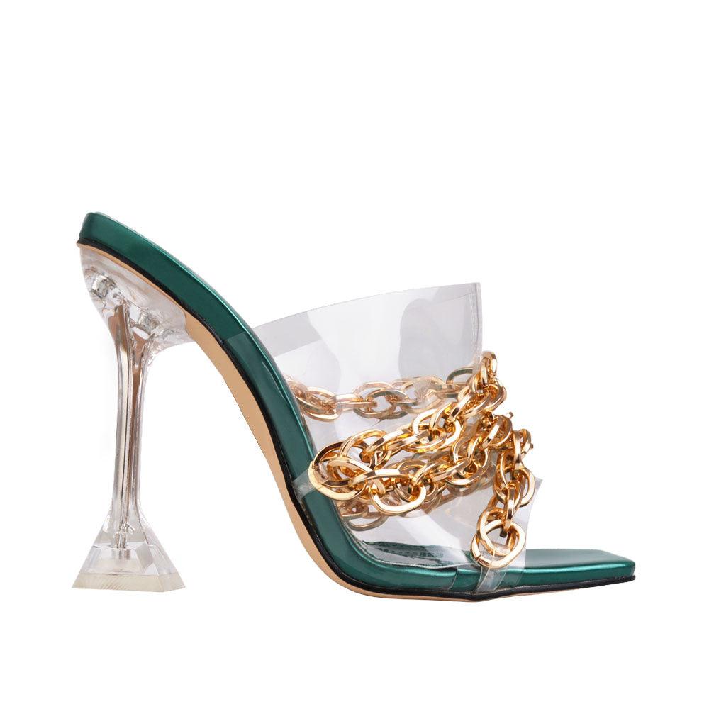 Slip-on transparent heels with a golden chain accent and translucent top in green color.