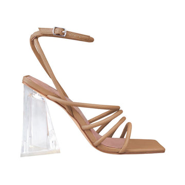 Transparent heels with strappy sandals design and ankle buck closure in nude color.