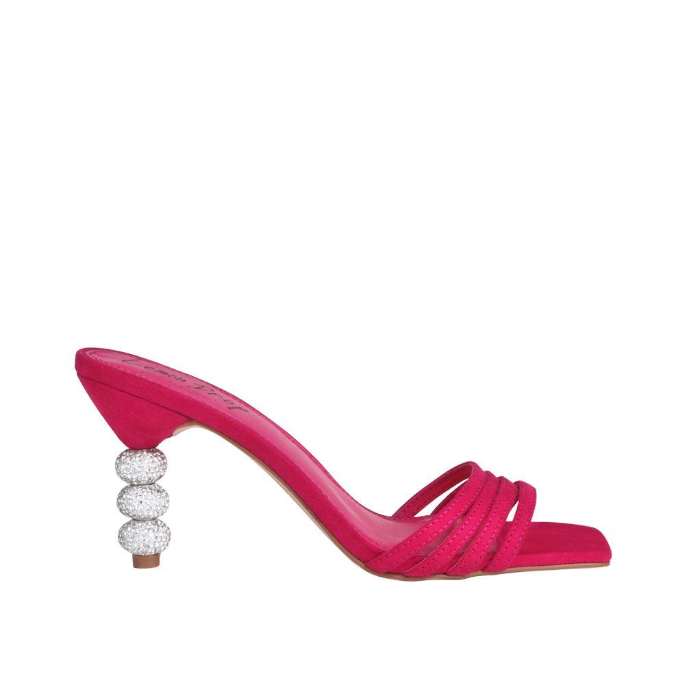 Slip-on fuchsia colored beaded heels with an open toe.