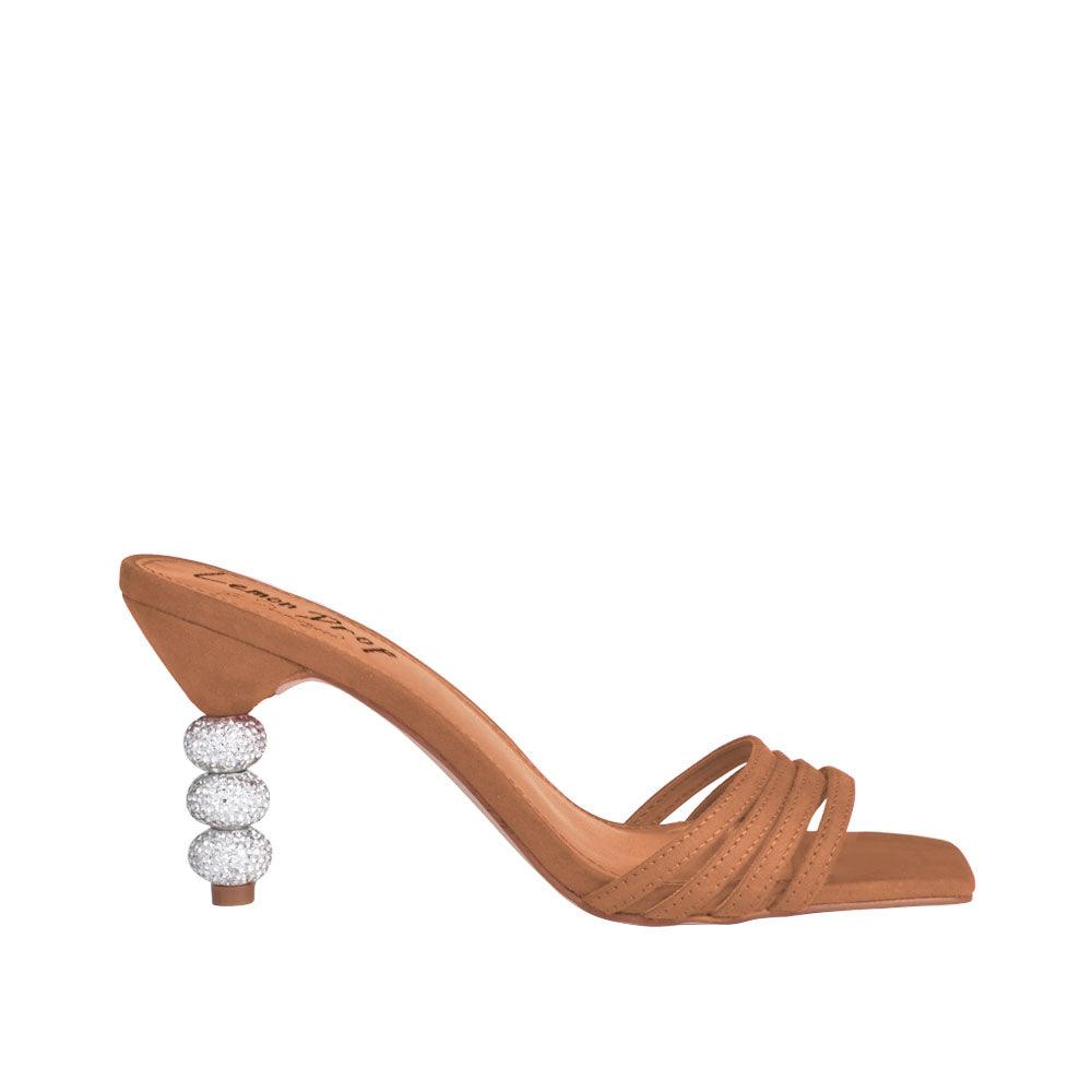 Tan colored beaded slip-on heels with an open toe.