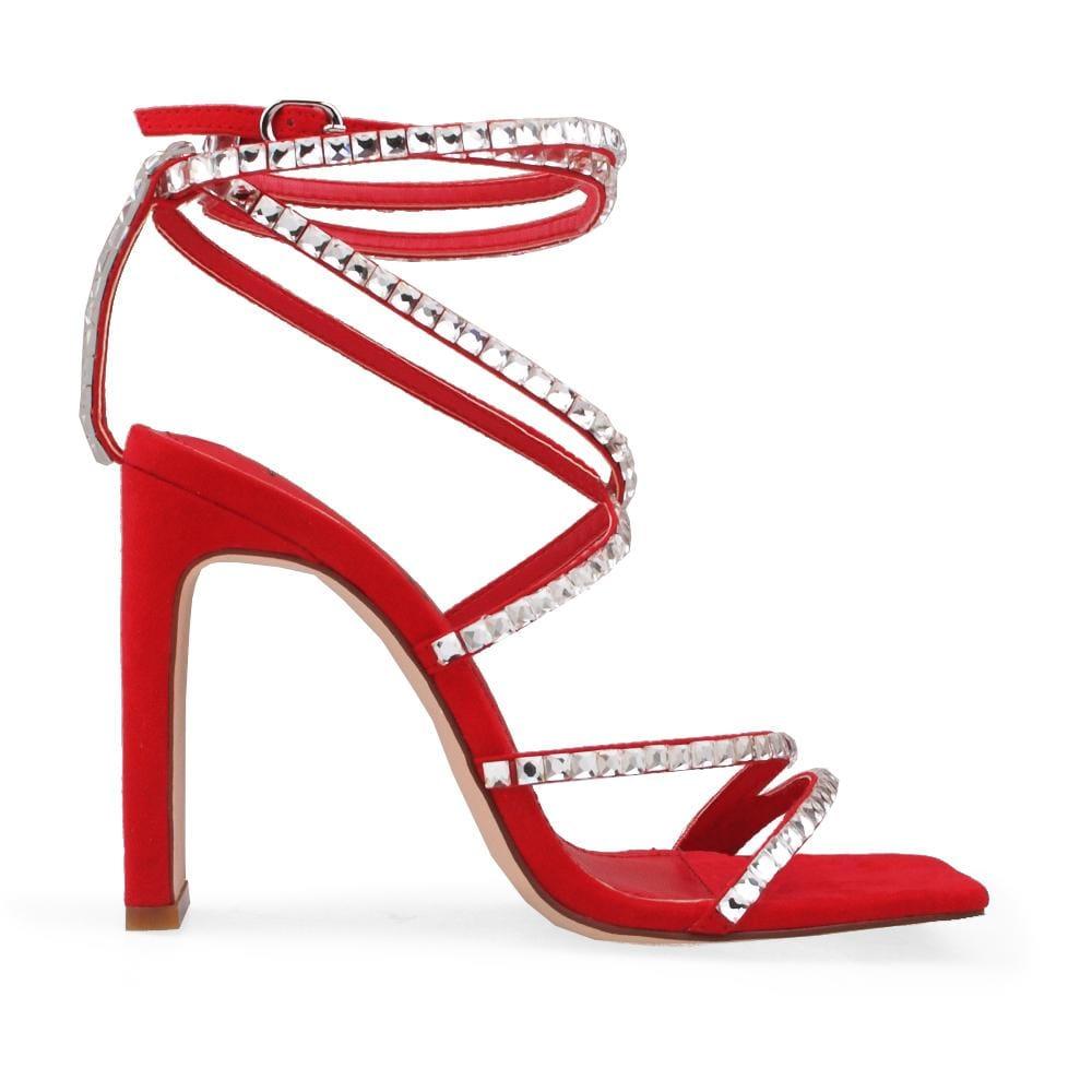 Heels in red with gem accented straps and an ankle buckle fastening.