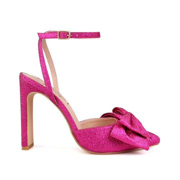 Fuchsia glitter colored heels with pointed toe, bow upper and ankle buckle closure