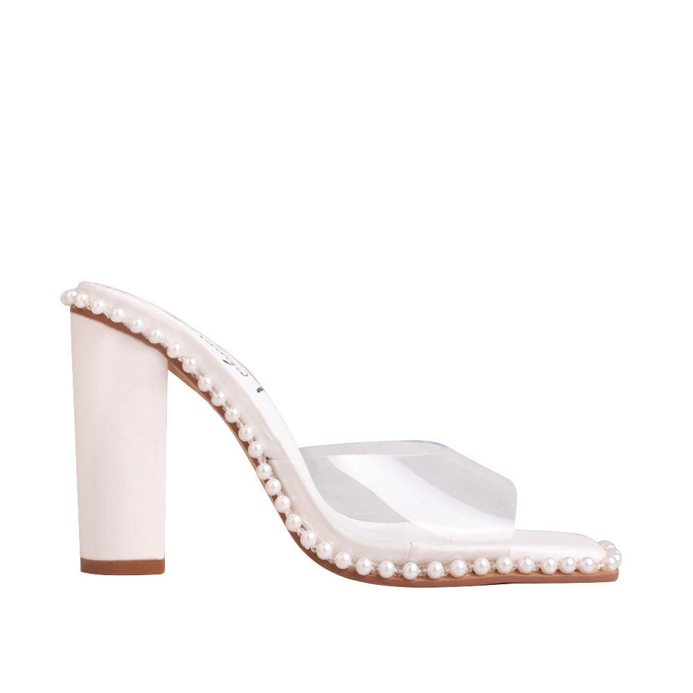 Women's white heels with side bead embellishment and a clear upper.