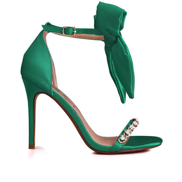 Heels in green with gem-encrusted strap and ankle buckle clasp with bow design.