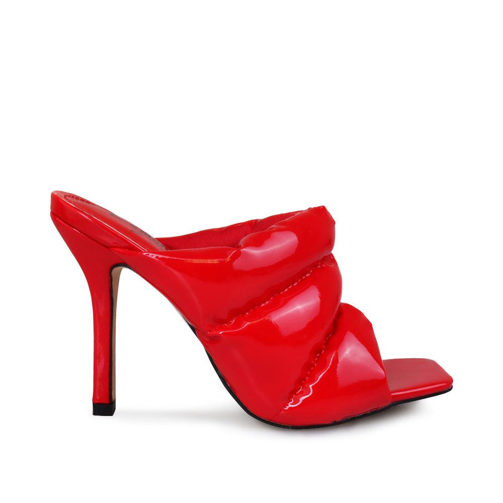 Women's red leather heels with slip-on design and an open toe.