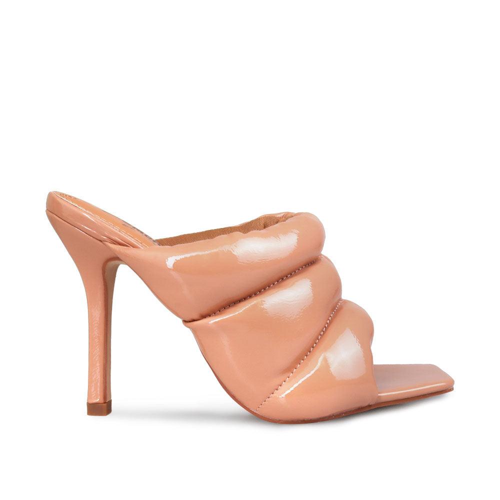 Women's nude leather heels with slip-on design and an open toe.