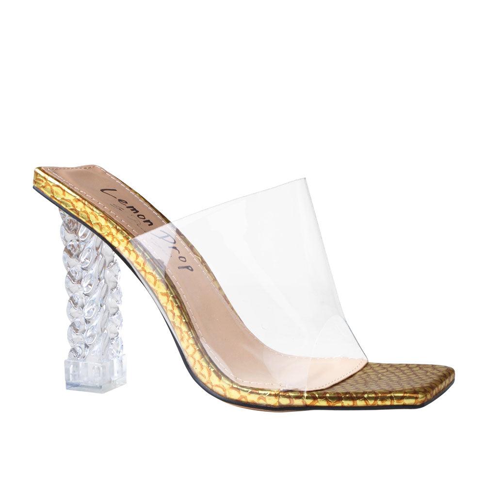 Clear vinyl upper with decorative women's block heel in gold-corner view