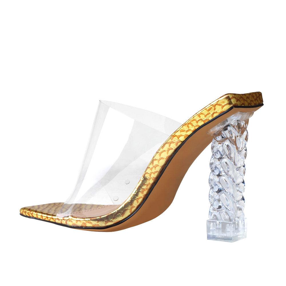 Clear vinyl upper with decorative women's block heel in gold-posterior view