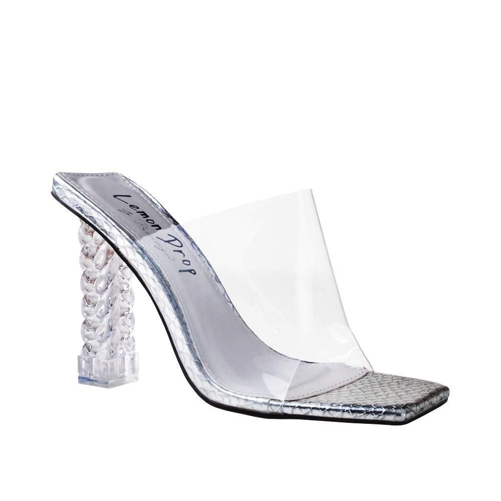 Clear vinyl upper with decorative women's block heel in silver-corner view